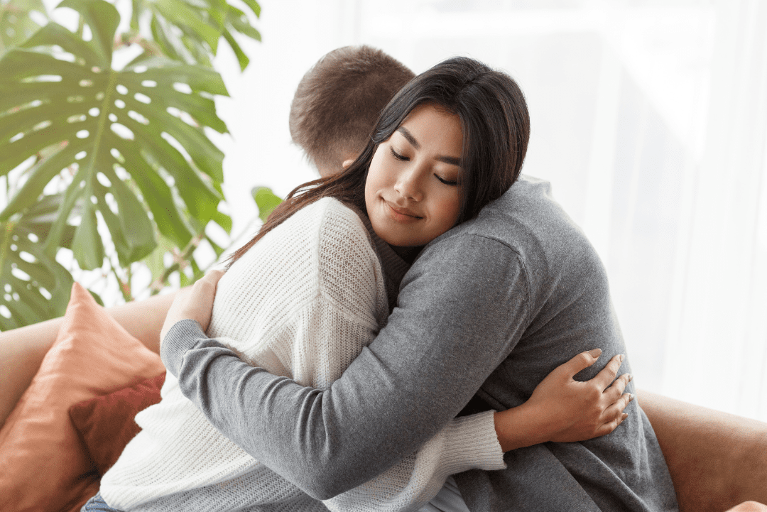 Young couple embraces during a couples counseling session with therapist