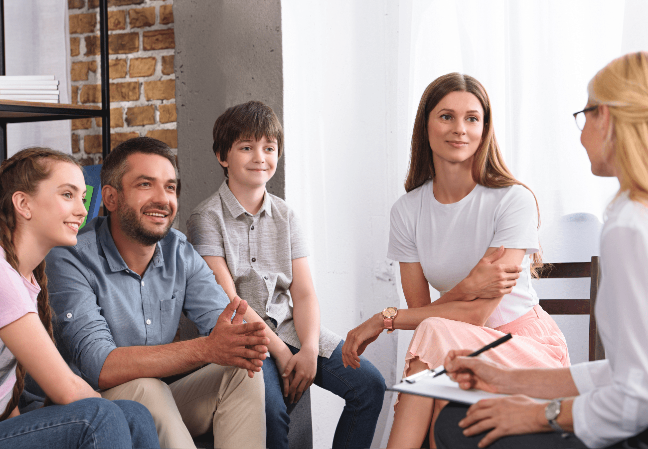 Happy family with two children attending family therapy session